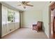 Bedroom with plush carpeting, a ceiling fan, and a window letting in natural light at 2026 Mcdaniel Mill Sw Rd, Conyers, GA 30094