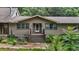 Inviting front entrance showcasing a wooden staircase, white door, and beautifully landscaped surroundings at 2026 Mcdaniel Mill Sw Rd, Conyers, GA 30094