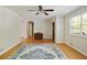 Bright living room with beautiful hardwood floors, a ceiling fan, and a large window overlooking the yard at 2026 Mcdaniel Mill Sw Rd, Conyers, GA 30094
