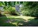 Wide open backyard featuring a shed, lawn, and mature trees, offering privacy at 2100 Shady Ln, Tucker, GA 30084