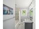 Fresh bathroom with new shower, white sink, dark cabinetry and mosaic tile flooring at 2100 Shady Ln, Tucker, GA 30084