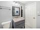 Charming bathroom featuring updated lighting, vanity and storage space at 2100 Shady Ln, Tucker, GA 30084