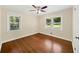 Bedroom with hardwood floors and natural light from two windows at 2100 Shady Ln, Tucker, GA 30084
