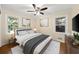 Stylishly furnished bedroom with large windows and refinished hardwood floors at 2100 Shady Ln, Tucker, GA 30084