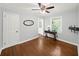 This bedroom features hardwood floors, a ceiling fan, and a window at 2100 Shady Ln, Tucker, GA 30084