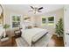 Bright bedroom featuring large windows, neutral walls, ceiling fan and beautiful hardwood floors at 2100 Shady Ln, Tucker, GA 30084