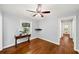 This bedroom features hardwood floors, a ceiling fan, and a window at 2100 Shady Ln, Tucker, GA 30084