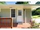 Inviting front porch with decorative railing and a white front door at 2100 Shady Ln, Tucker, GA 30084