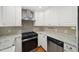 Modern kitchen features stainless steel appliances, granite countertops and white cabinetry at 2100 Shady Ln, Tucker, GA 30084
