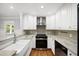 Modern kitchen with white cabinets, granite countertops and a stainless range at 2100 Shady Ln, Tucker, GA 30084