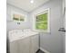 Laundry room with washer and dryer with natural light from a window at 2100 Shady Ln, Tucker, GA 30084