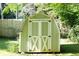 This backyard shed features doors with cross design on a well manicured lawn at 2100 Shady Ln, Tucker, GA 30084