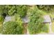 Birds eye view of a gray home with a driveway, lush trees, and surrounding greenery at 4339 Sasanqua Ct, Tucker, GA 30084