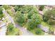 An aerial view showing the gray home surrounded by mature trees in a quiet neighborhood at 4339 Sasanqua Ct, Tucker, GA 30084