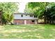 Expansive backyard view with mature trees, a well-kept lawn, and a brick home exterior at 4339 Sasanqua Ct, Tucker, GA 30084
