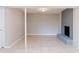 Spacious basement featuring a painted brick fireplace, tile flooring, and modern lighting at 4339 Sasanqua Ct, Tucker, GA 30084