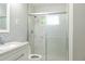 Bathroom featuring a shower with glass door, light countertops and sink at 4339 Sasanqua Ct, Tucker, GA 30084
