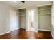 Bedroom with hardwood floors, built in shelving and a view into the bathroom at 4339 Sasanqua Ct, Tucker, GA 30084
