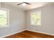 Bedroom with hardwood floors and two windows offering natural light at 4339 Sasanqua Ct, Tucker, GA 30084
