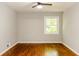 Bedroom with hardwood floors, a ceiling fan, and a window offering natural light at 4339 Sasanqua Ct, Tucker, GA 30084
