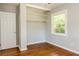 Bedroom with hardwood floors, large closet with built in shelving and one window at 4339 Sasanqua Ct, Tucker, GA 30084