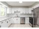 Bright kitchen featuring white cabinets, stainless steel appliances, and granite countertops at 4339 Sasanqua Ct, Tucker, GA 30084