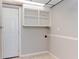 Bright laundry room featuring tile flooring, an exterior door, and ample overhead storage at 4339 Sasanqua Ct, Tucker, GA 30084