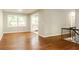 Spacious living room featuring wood floors, a large window, and seamless access to the kitchen at 4339 Sasanqua Ct, Tucker, GA 30084