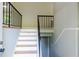A staircase with white risers, wooden treads, and a black metal railing at 4339 Sasanqua Ct, Tucker, GA 30084