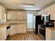 Well-lit kitchen featuring wood floors, light-colored cabinets, and stainless steel appliances at 5105 N Bridges Dr, Alpharetta, GA 30022