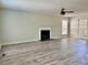 Bright living room featuring fireplace, ceiling fan, and lots of natural light at 5105 N Bridges Dr, Alpharetta, GA 30022