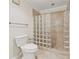 Bathroom featuring a tiled shower with glass block and modern fixtures at 1416 Oakridge Cir, Decatur, GA 30033