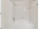Bright bathroom featuring a tub with a tile surround and a shower head at 1416 Oakridge Cir, Decatur, GA 30033