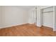 A bedroom featuring hardwood floors, a closet with bifold doors, and neutral paint at 1416 Oakridge Cir, Decatur, GA 30033