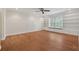Spacious bedroom with built-in shelves and wood-look flooring, illuminated by recessed lights at 1416 Oakridge Cir, Decatur, GA 30033