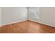 Bright bedroom featuring hardwood floors and a window with white shutters at 1416 Oakridge Cir, Decatur, GA 30033