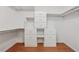 Walk-in closet with a built-in shelving unit and wood-look floors at 1416 Oakridge Cir, Decatur, GA 30033
