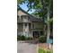 View of a well-maintained condo with a covered porch and verdant landscaping at 1416 Oakridge Cir, Decatur, GA 30033