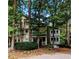 Inviting exterior of a multi-story condo surrounded by lush greenery and mature trees at 1416 Oakridge Cir, Decatur, GA 30033
