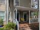 Charming front porch with brick steps, white railings, and a cozy seating area at 1416 Oakridge Cir, Decatur, GA 30033