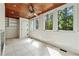 Bright sunroom with wood ceilings, tiled floors, a fireplace and views of the backyard at 1416 Oakridge Cir, Decatur, GA 30033