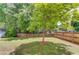 Large backyard showcases a beautiful, mature tree and well-maintained lawn at 1657 Hampton Woods Way, Lawrenceville, GA 30043