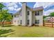 Well-maintained backyard featuring green lawn, privacy fence, and mature trees at 1657 Hampton Woods Way, Lawrenceville, GA 30043