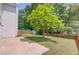Expansive backyard features a mature tree, lush lawn, and privacy fence at 1657 Hampton Woods Way, Lawrenceville, GA 30043