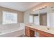 Bright bathroom featuring a double vanity, soaking tub and natural light at 1657 Hampton Woods Way, Lawrenceville, GA 30043