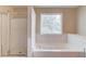 Bright bathroom featuring a soaking tub and separate glass enclosed shower at 1657 Hampton Woods Way, Lawrenceville, GA 30043