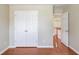 A bedroom with hardwood floors, and double closets at 1657 Hampton Woods Way, Lawrenceville, GA 30043