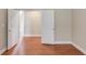 Well-lit bedroom featuring hardwood floors and an open doorway at 1657 Hampton Woods Way, Lawrenceville, GA 30043