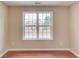 A room with hardwood floors showcasing a large window with neighborhood views at 1657 Hampton Woods Way, Lawrenceville, GA 30043