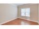 Bright bedroom featuring hardwood floors and a large window at 1657 Hampton Woods Way, Lawrenceville, GA 30043